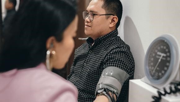 Young man getting his blood pressure checked